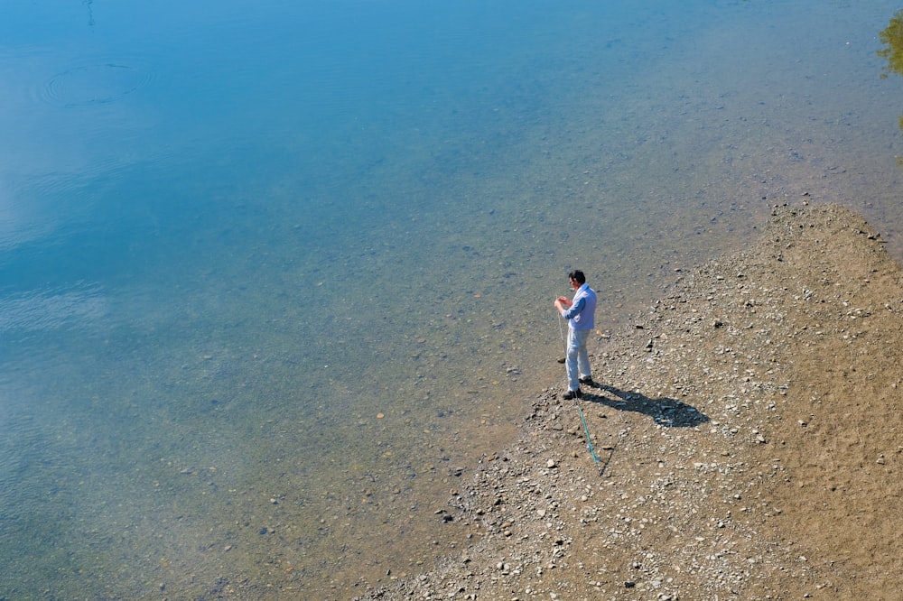 man standing on seashore during daytime