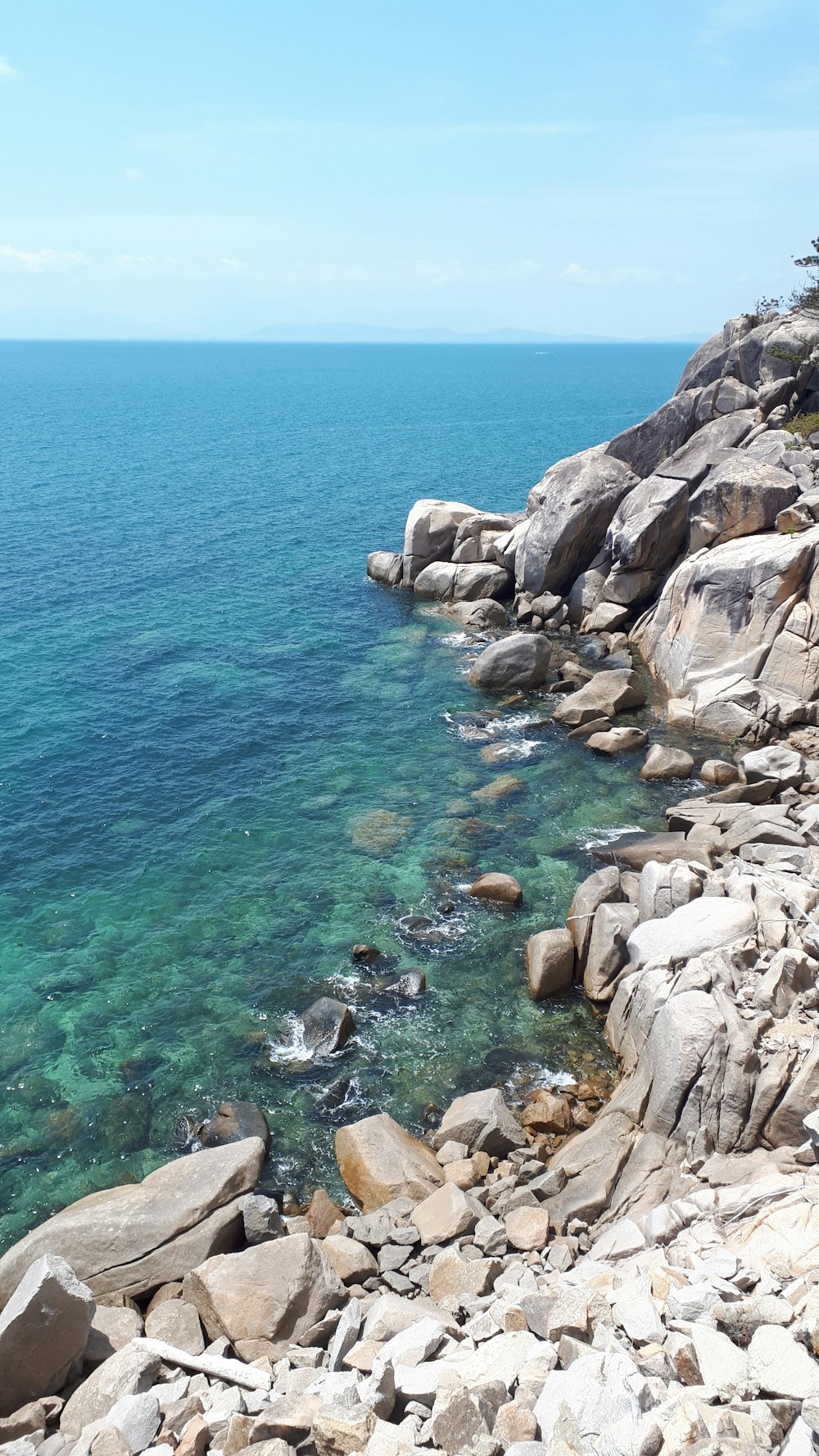 a view of the ocean from a rocky shore