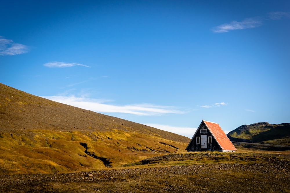 brown and white wooden house near mountain during daytime