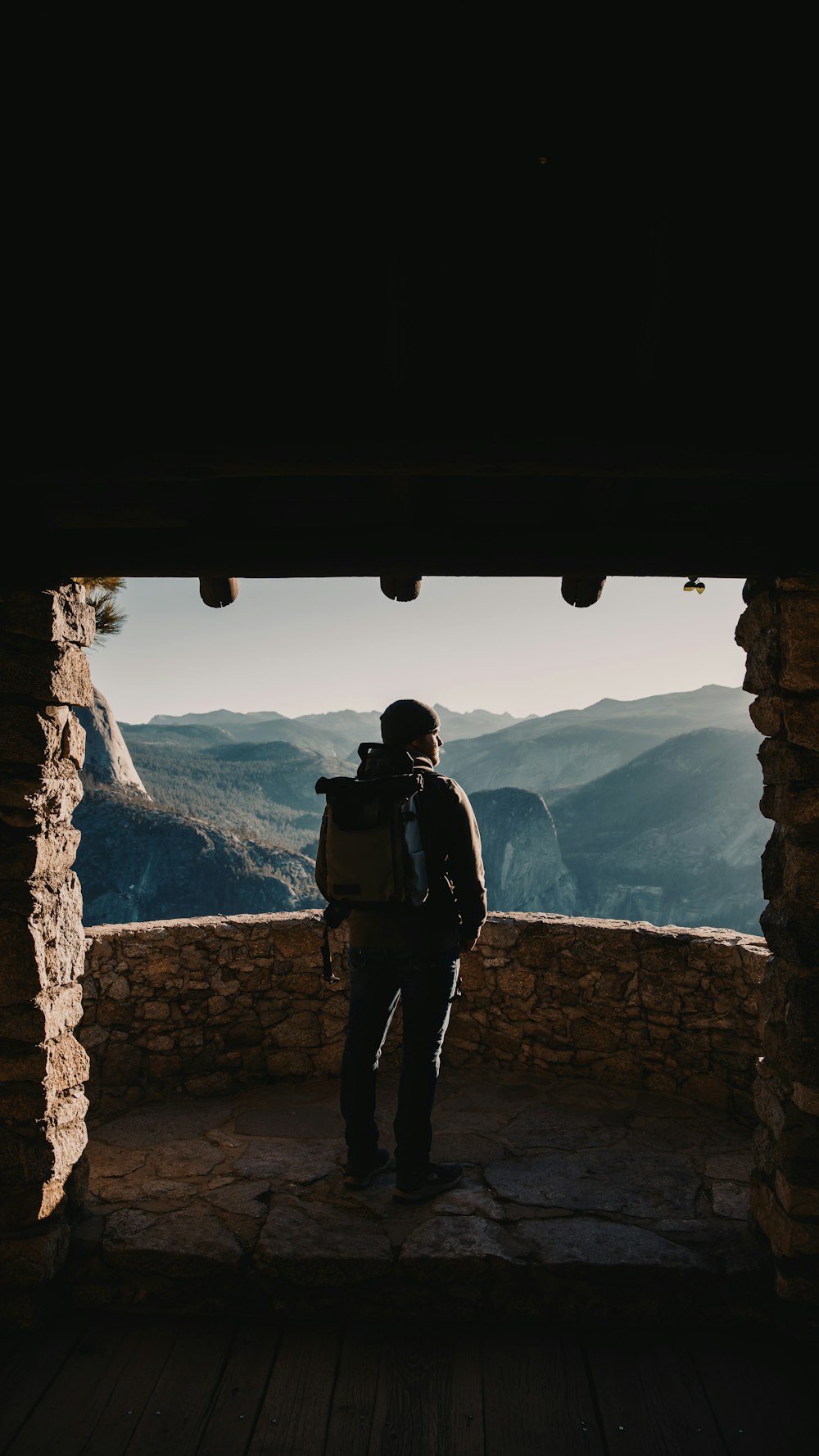 man standing on balcony with concrete fence