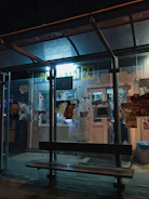 A modern bus stop shelter wrapped with eye-catching promotional visuals.