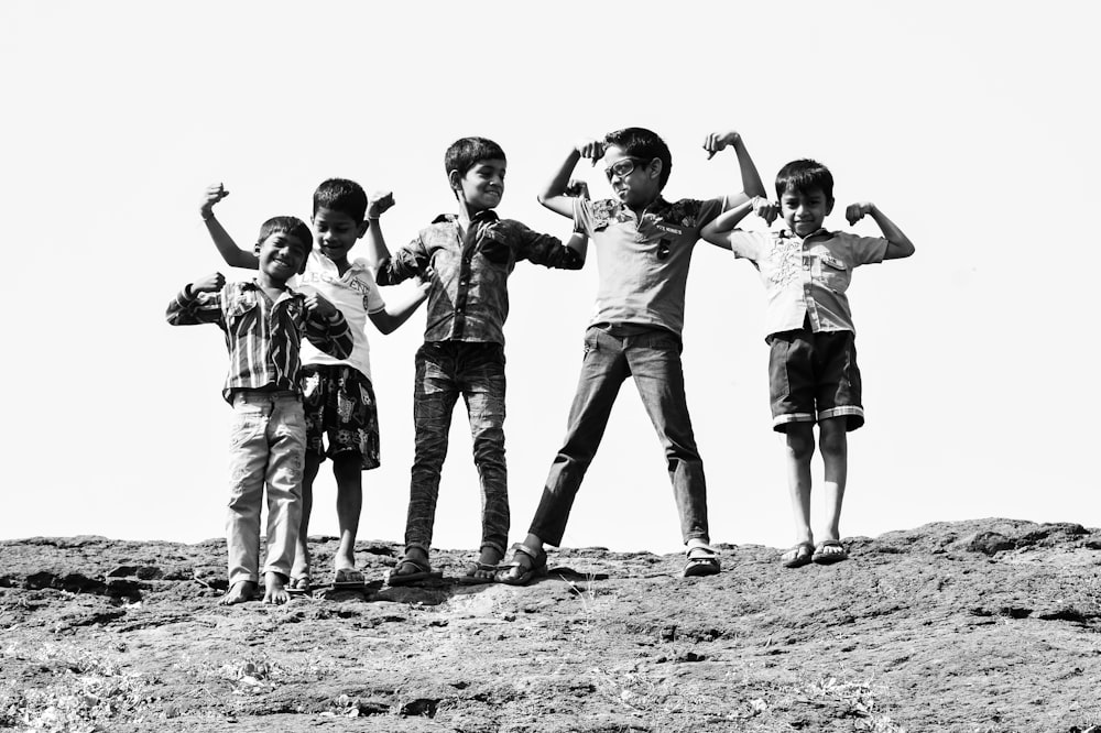 grayscale photography of five boys