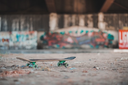 Skateboard on the ground in an urban setting with graffiti
