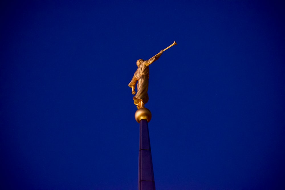 angel playing horn standing statue