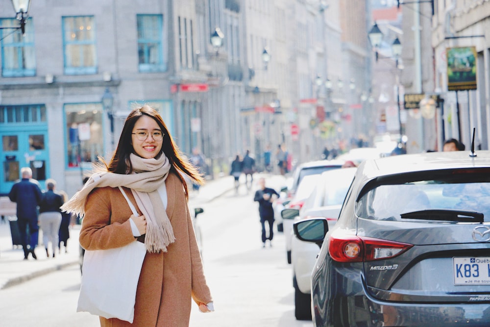 people near cars and buildings during day