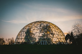 A geodesic dome set in a natural landscape, showcasing its unique structure.