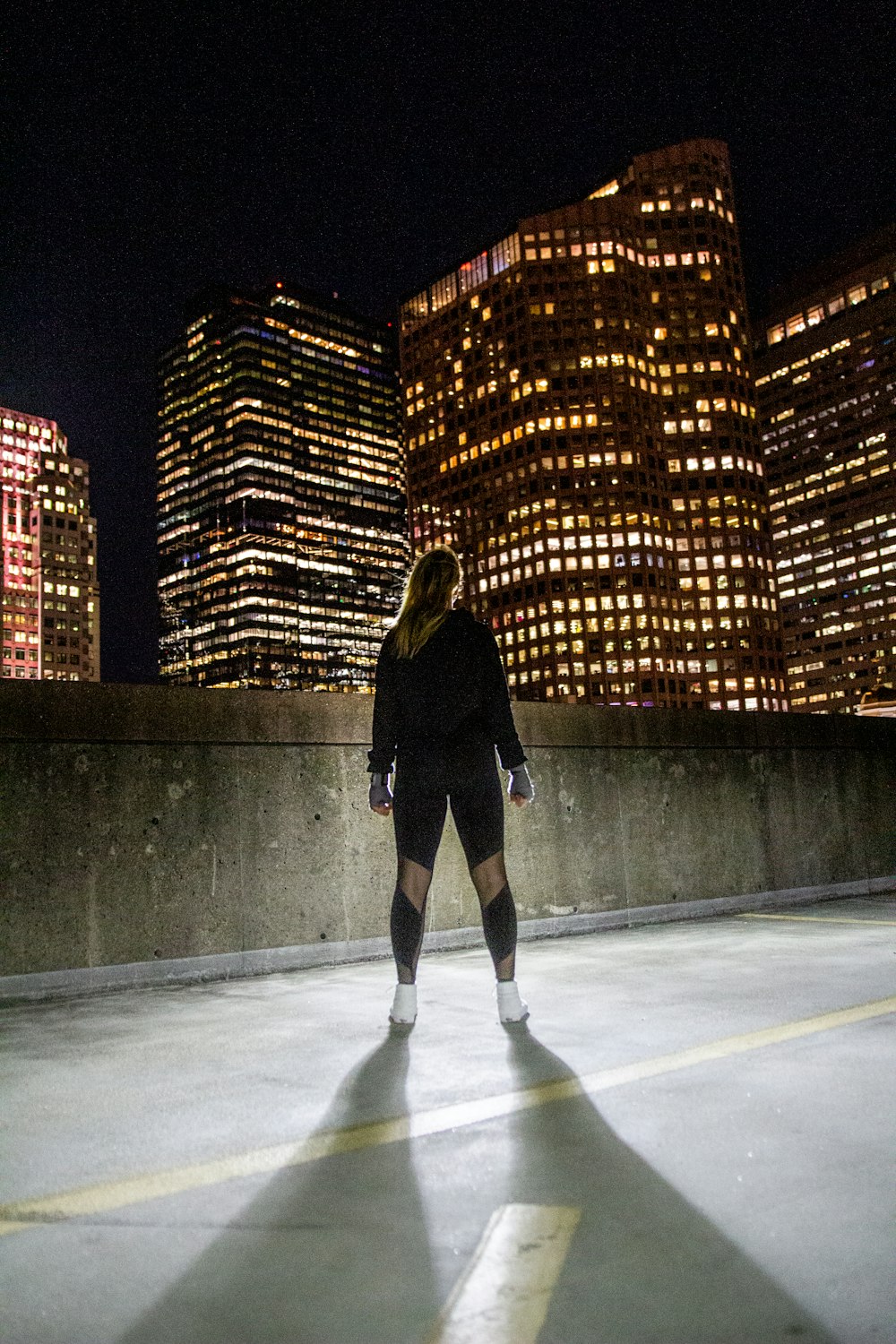 woman wearing black jacket standing in front of the building