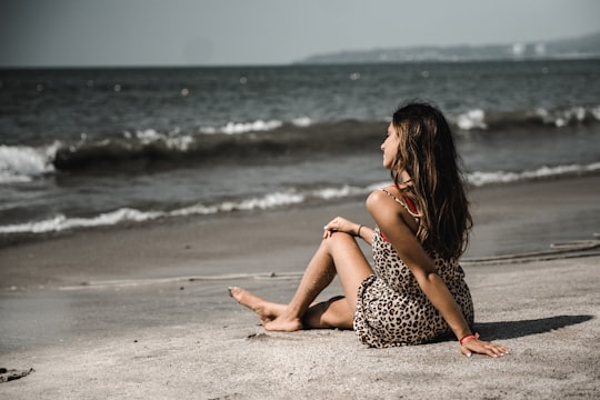 woman sitting on sand at beach in Puerto Vallarta Mexico