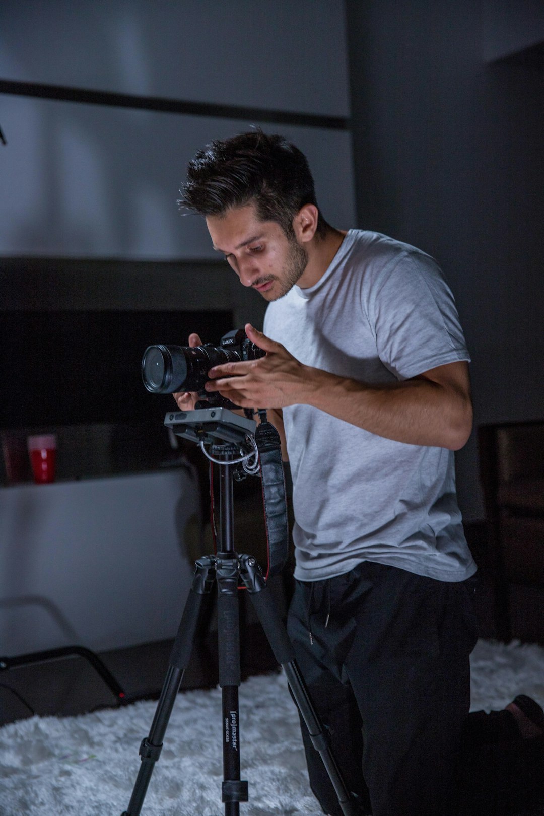 man in room with DSLR camera