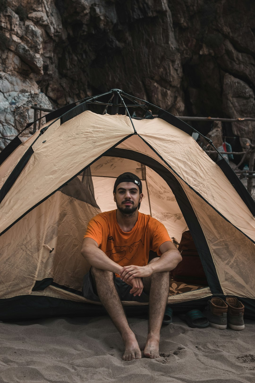 man sitting inside tent during daytime