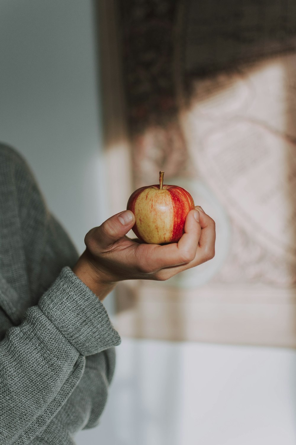 person holding yellow apple fruit