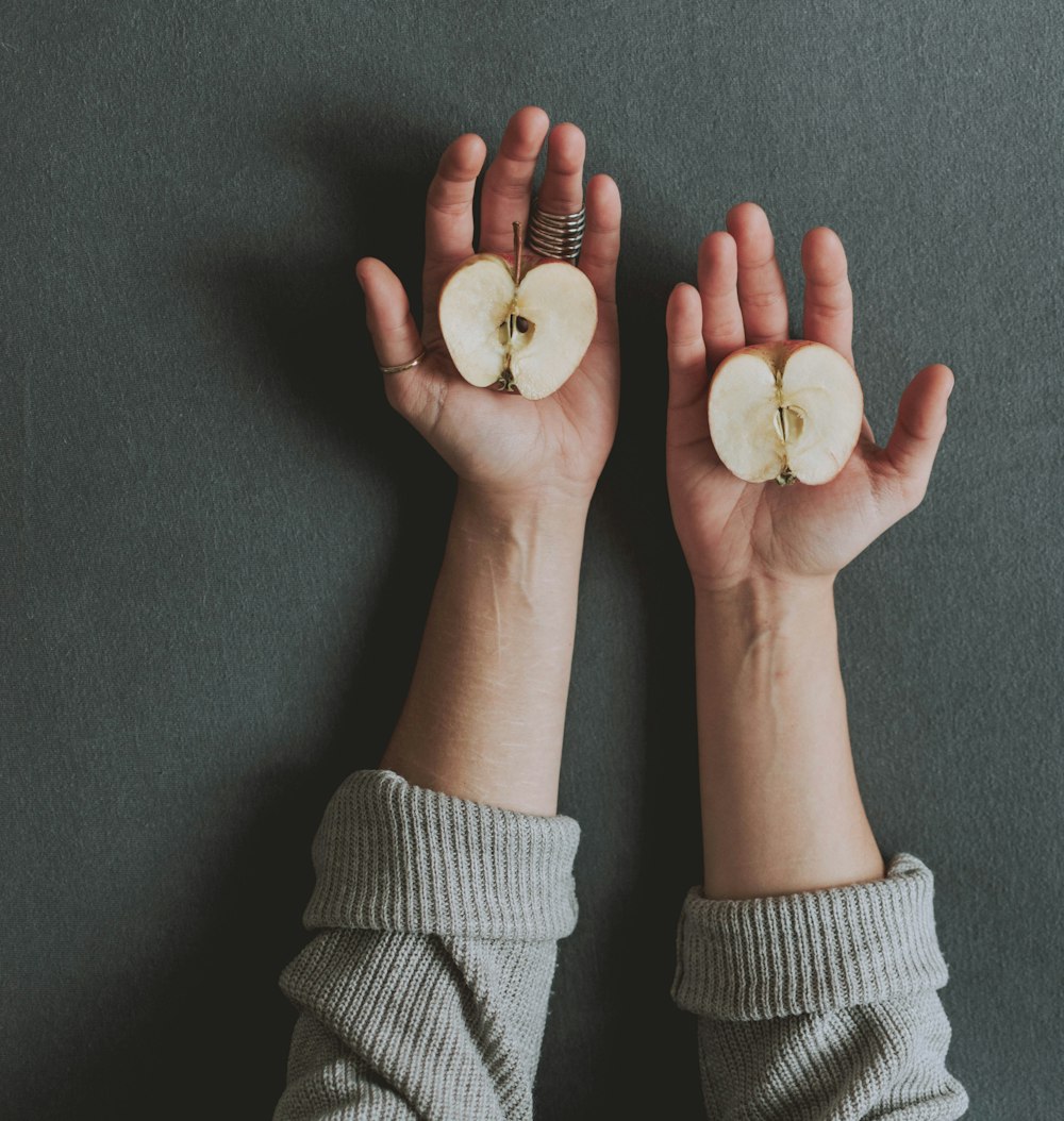 unknown person holding sliced apples