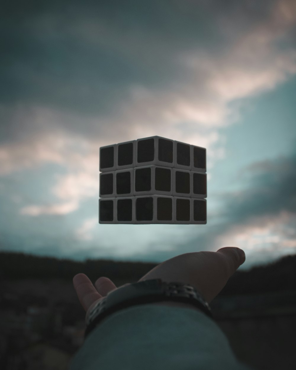 person tossing Rubik's cube