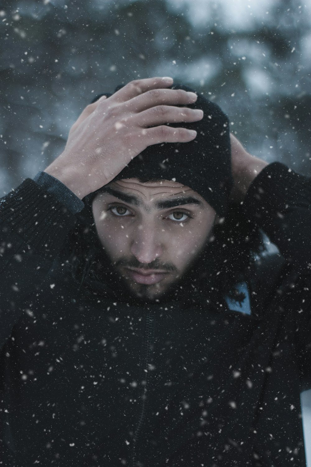 man in black jacket and knit cap