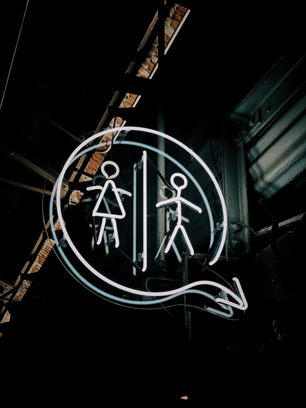 a neon sign hanging from the side of a building