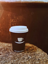 A warm, minimalist coffee cup on a beige textured background reflecting traditional Anatolian coffee culture.