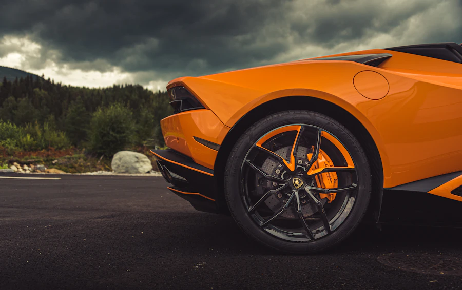 Close-up of the alloy wheel and low-profile tire on an orange sports car