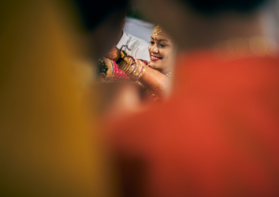 selective focus photography of smiling woman wearing bangles