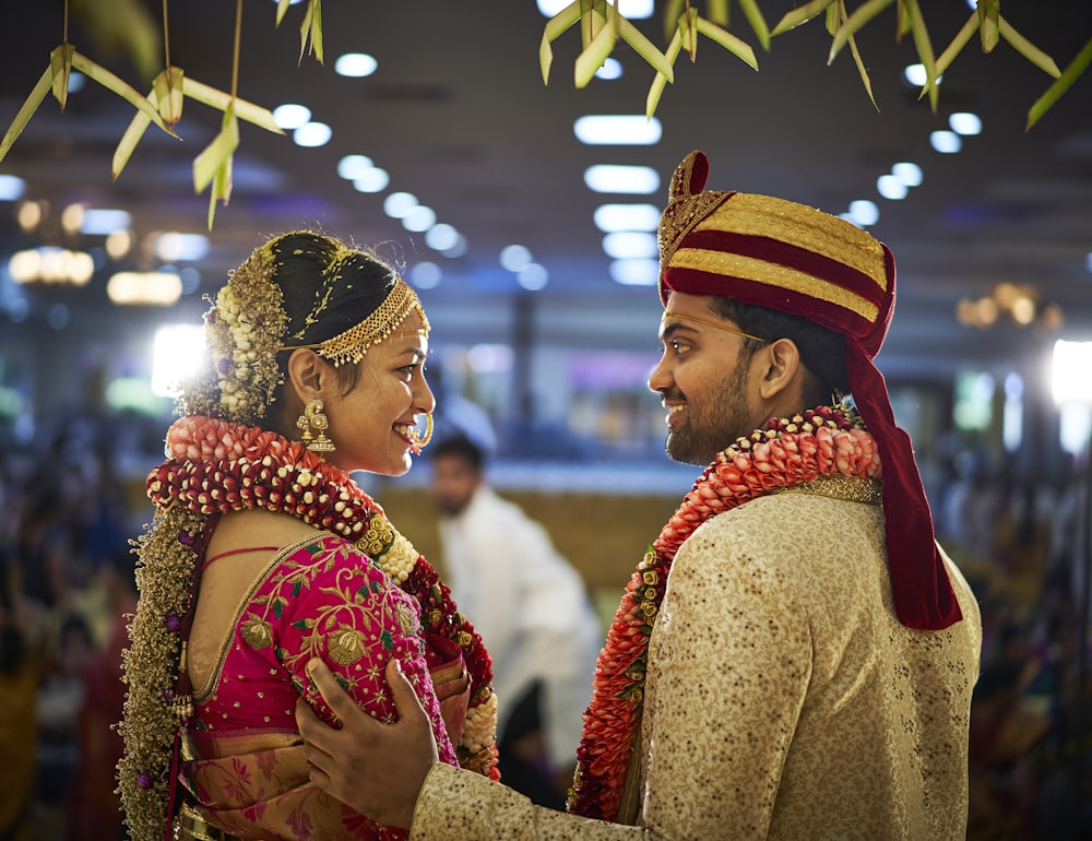 woman in pink traditional dress and man in gold sherwani