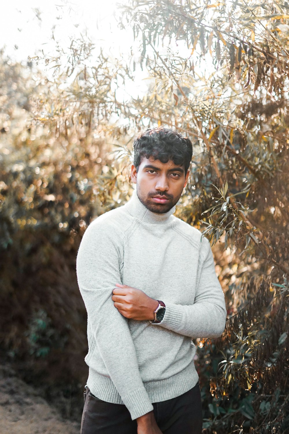 man standing beside plant