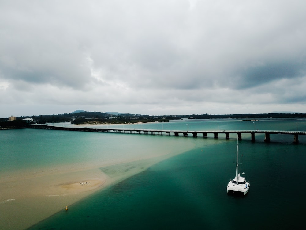 white yacht on body of water