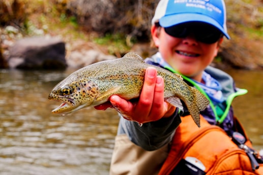 man holding brown fish