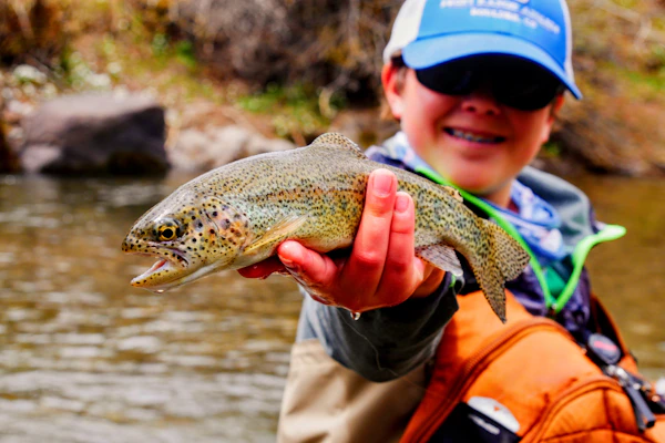 Angler holding a brown trout