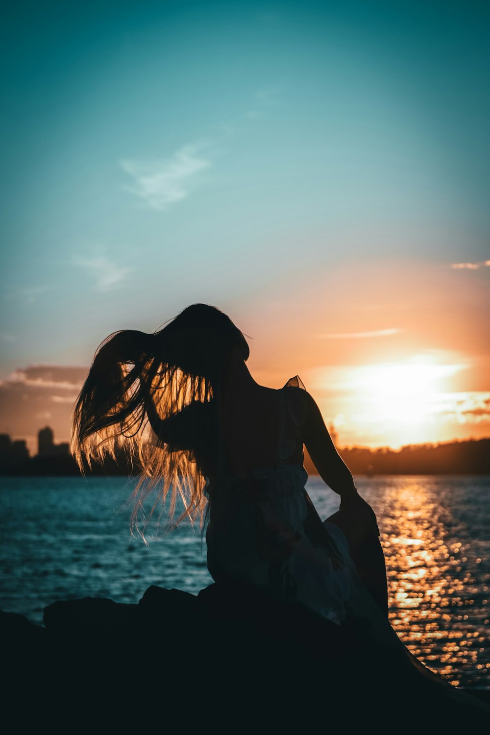 silhouette of woman on stone