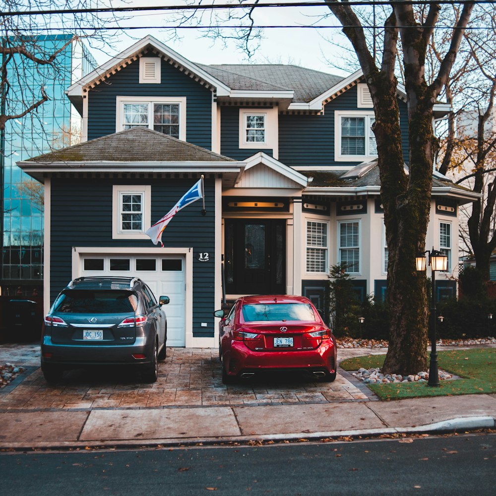 two different vehicles parking near house