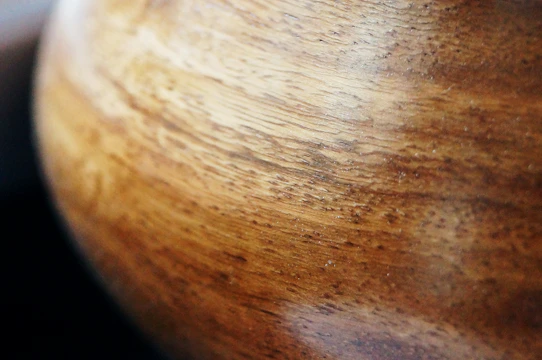 Close-up of finely crafted wooden furniture showcasing natural grain and smooth finish.