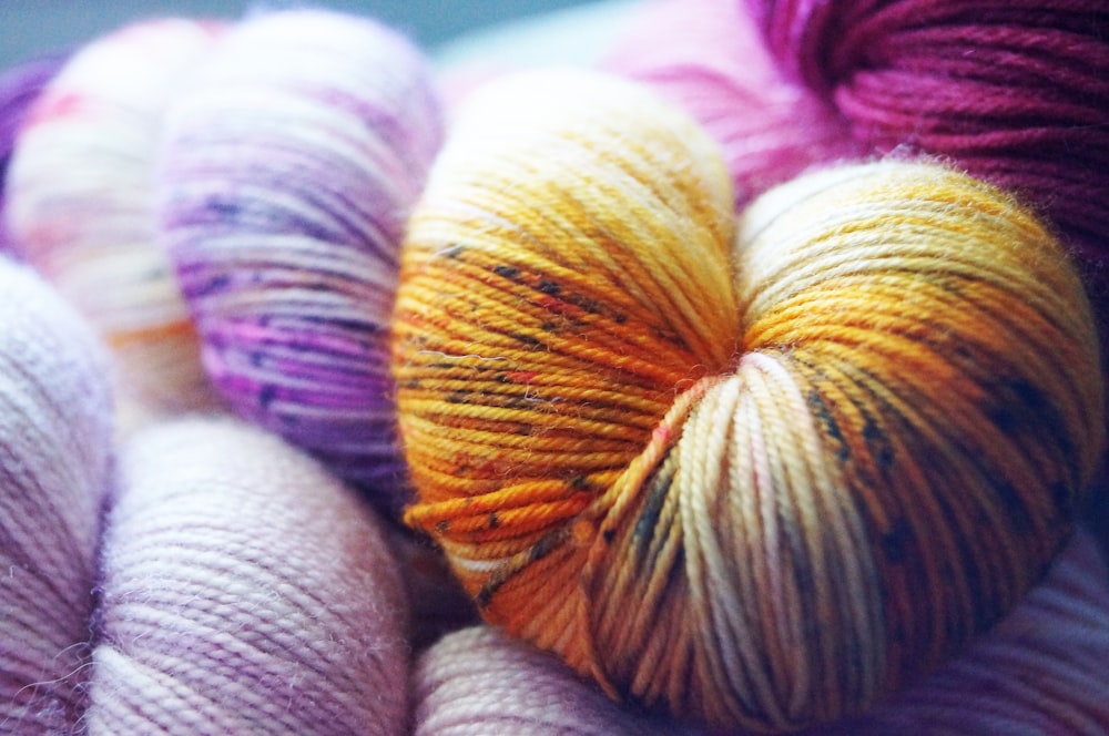 yellow, purple, and pink yarn