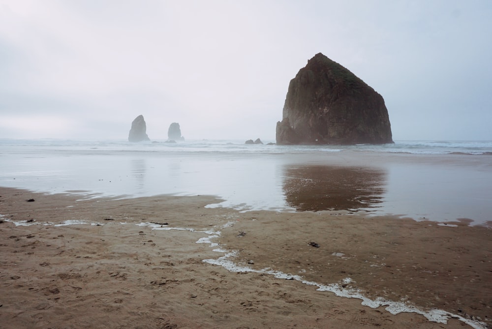 landscape photography of rock formations in the sea