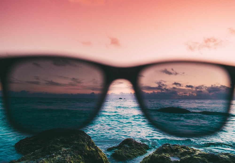 black Wayfarer-style sunglasses near body of water