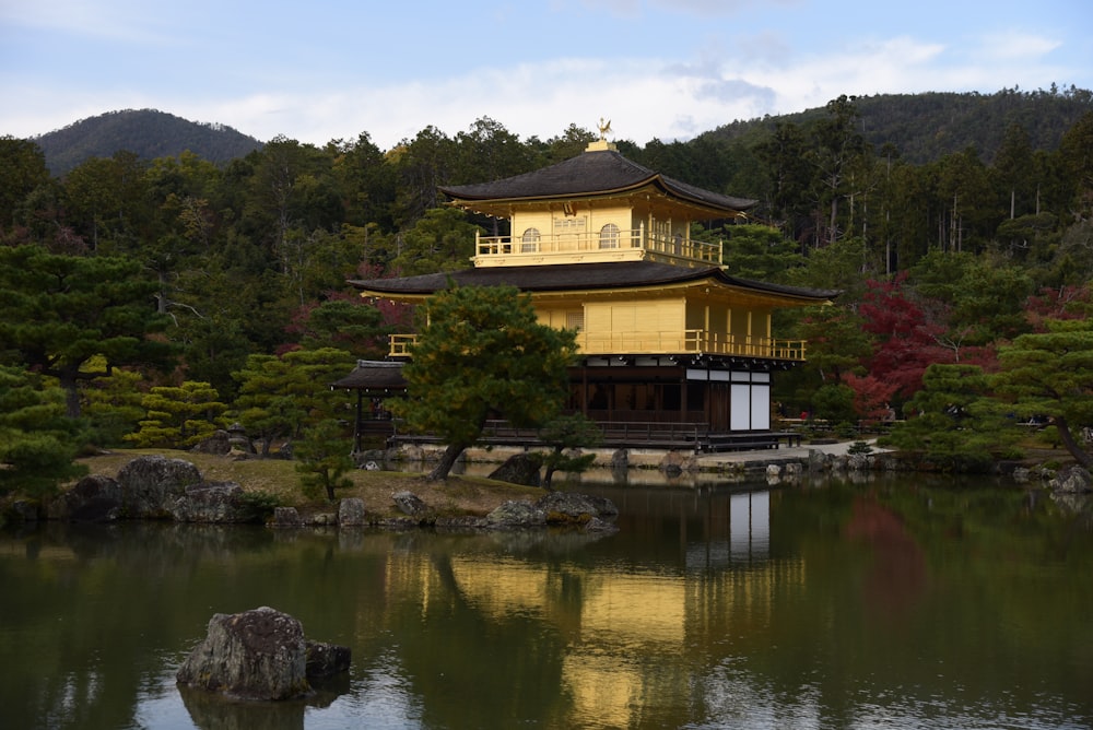 yellow and black concrete house beside body of water