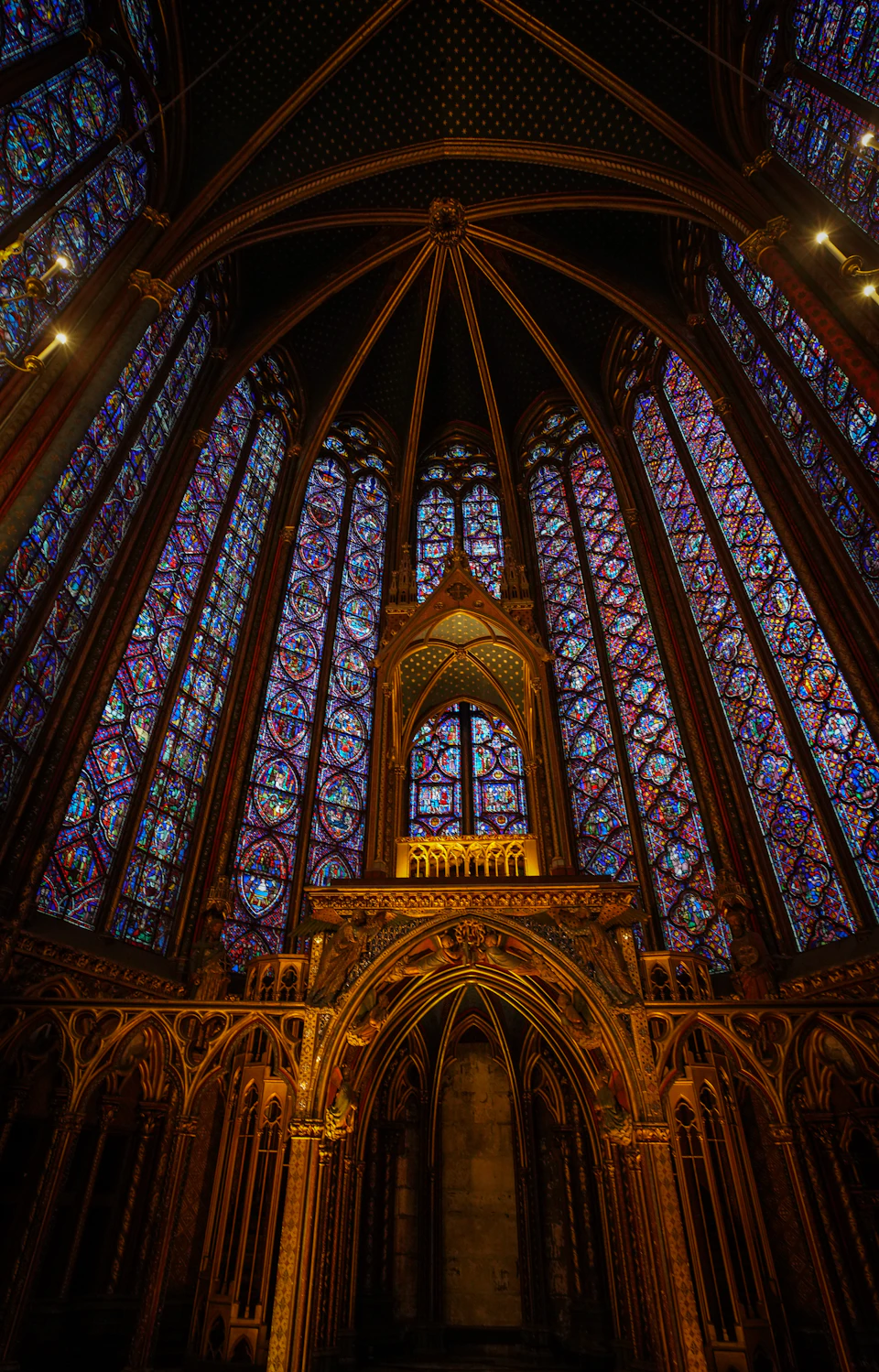 Large ornate cathedral with high ceiling and numerous stained glass windows filling space