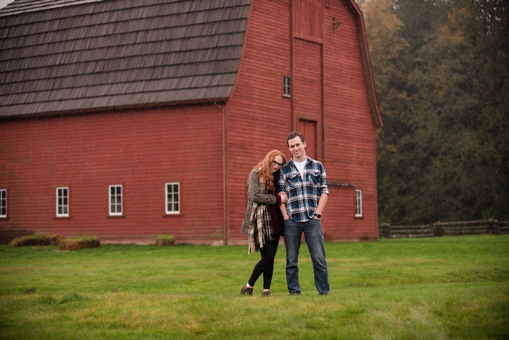 man and woman near barn
