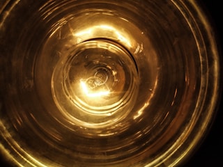 Close-up of a glowing copper vortex coil emitting soft harmonic light in a serene healing space.