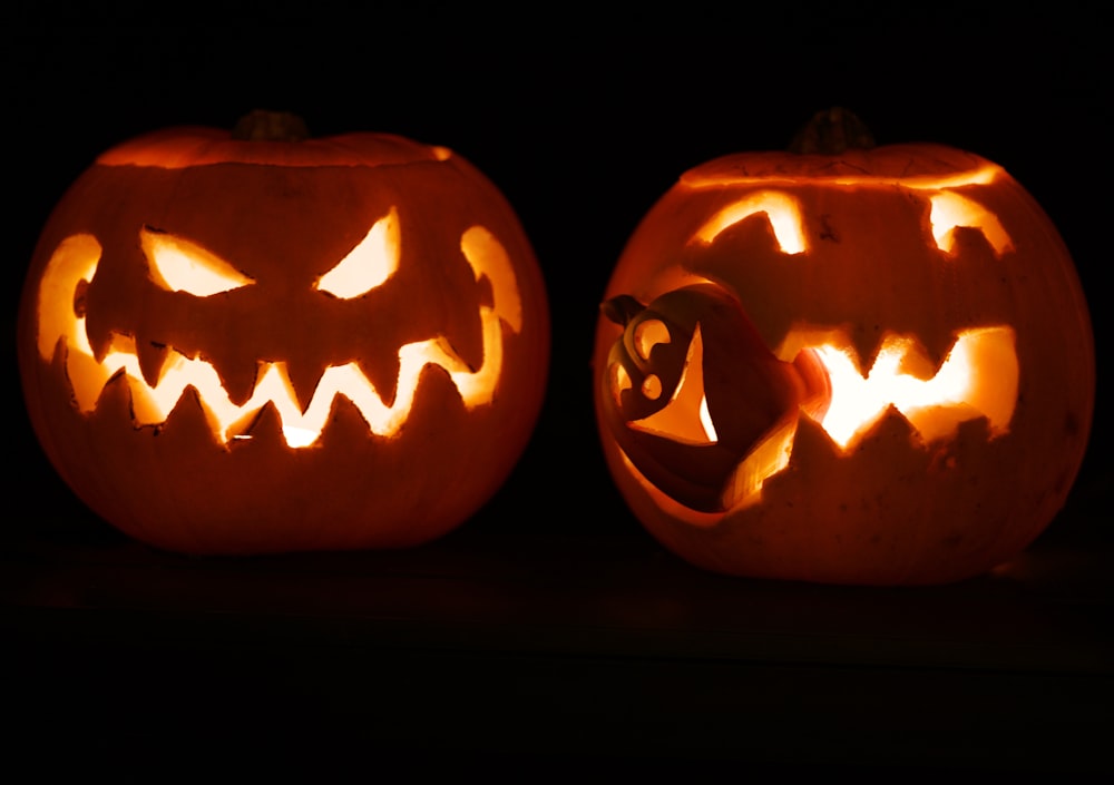 two lighted orange Jack-o-lanterns