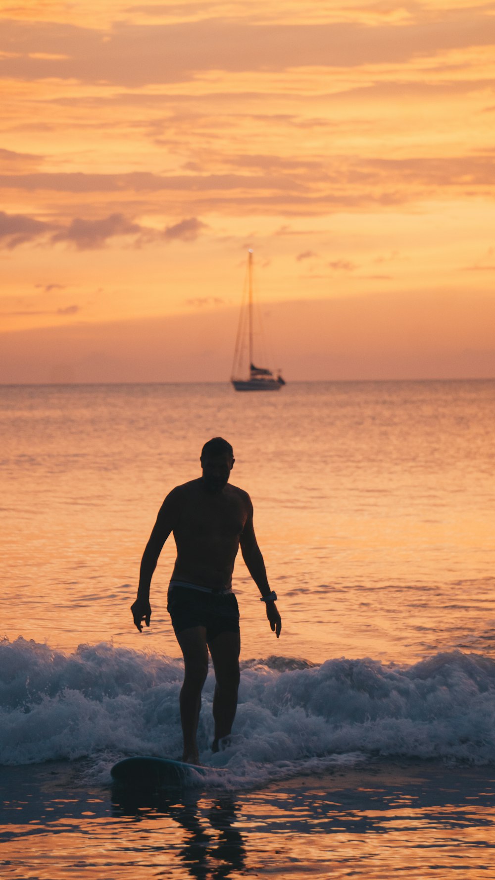 surfer riding wave during golden hour