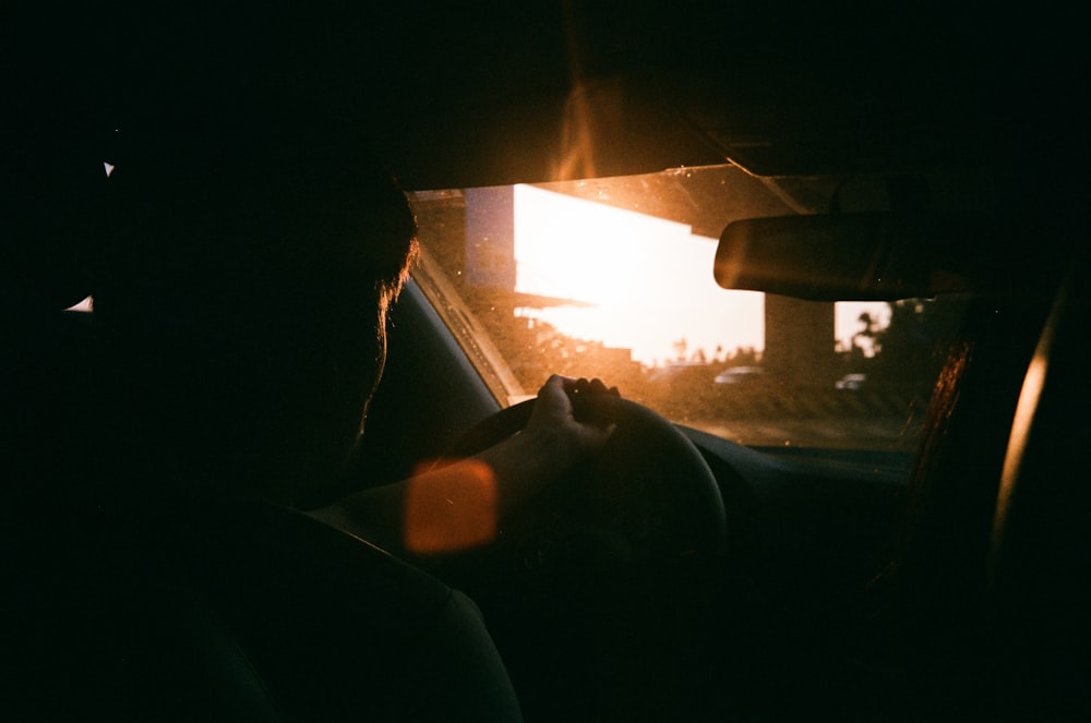 man riding inside vehicle during daytime