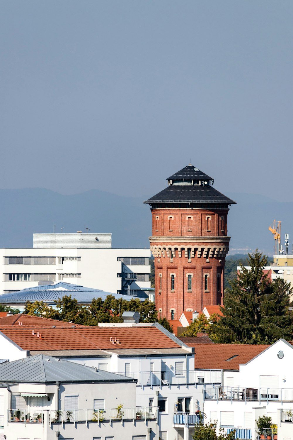 brown concrete tower beside trees