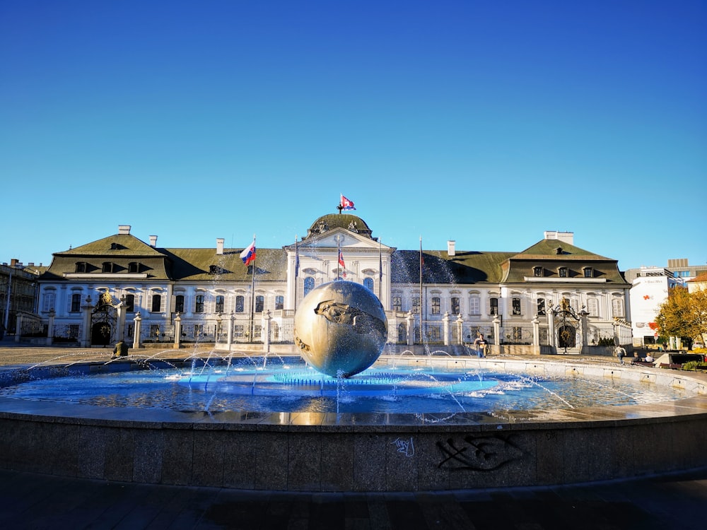 water fountain in front of building during day