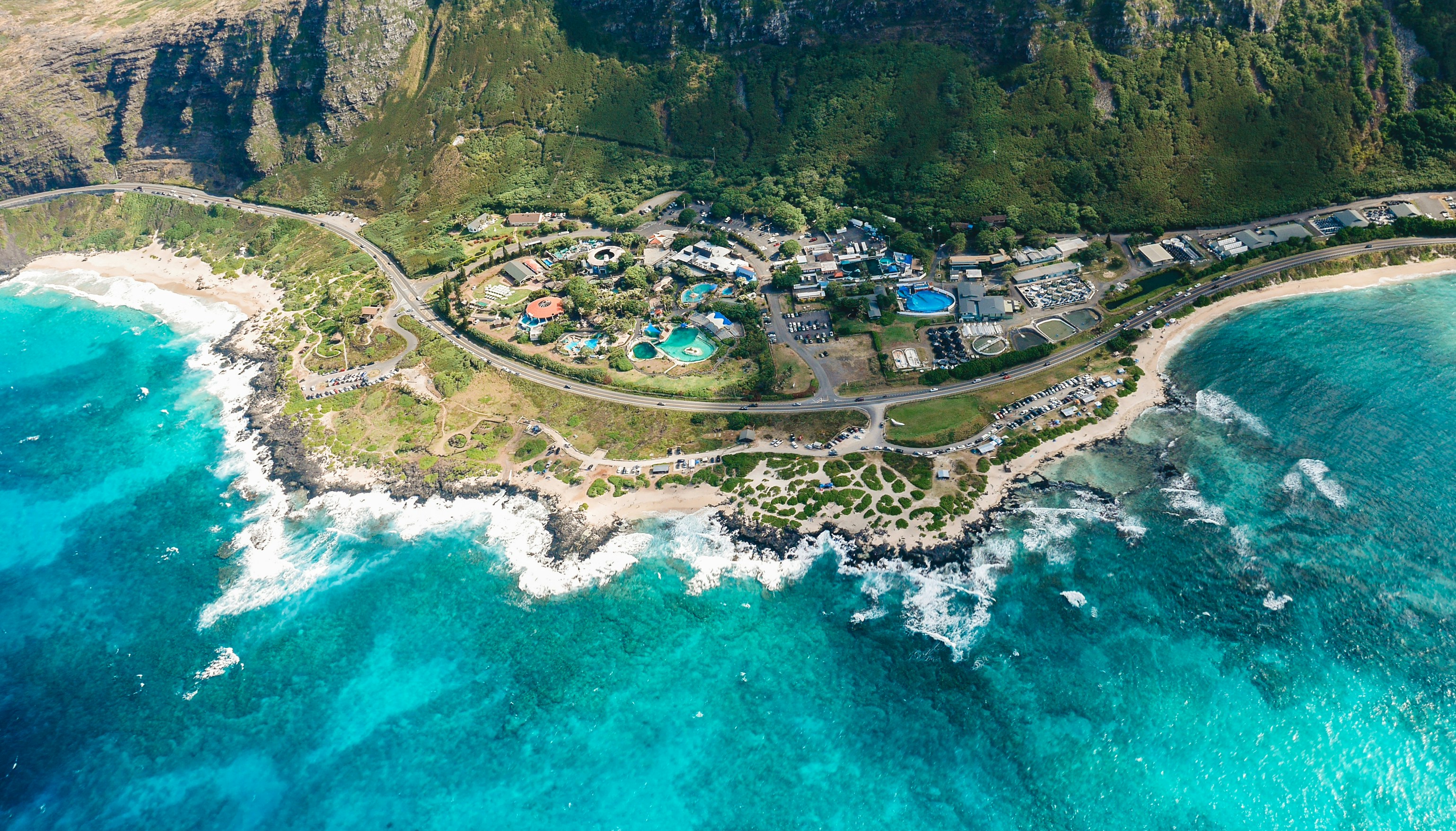 aerial photography of green land near blue sea, Aerial photo of the Turtle Bay Resort on the Oahu island in Hawaii. Features the beaches, tropical resort and the mountain range behind it.