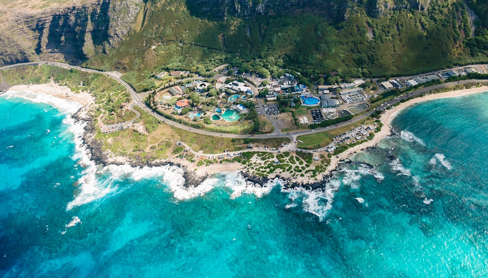 aerial photography of green land near blue sea