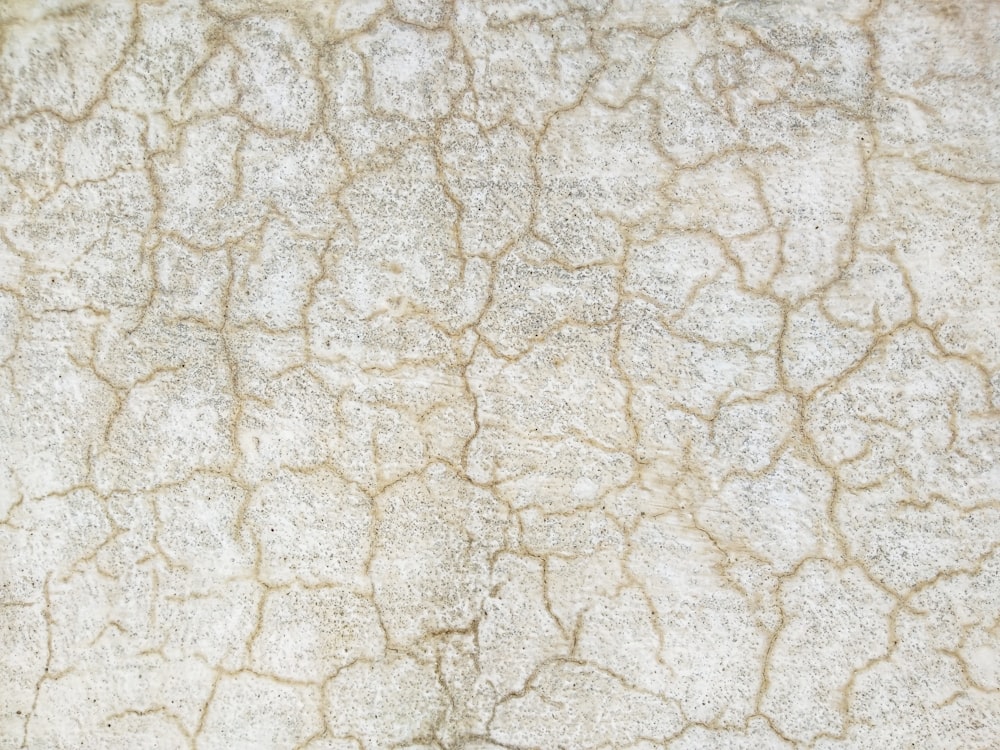 a close up of a wall with cracks in it