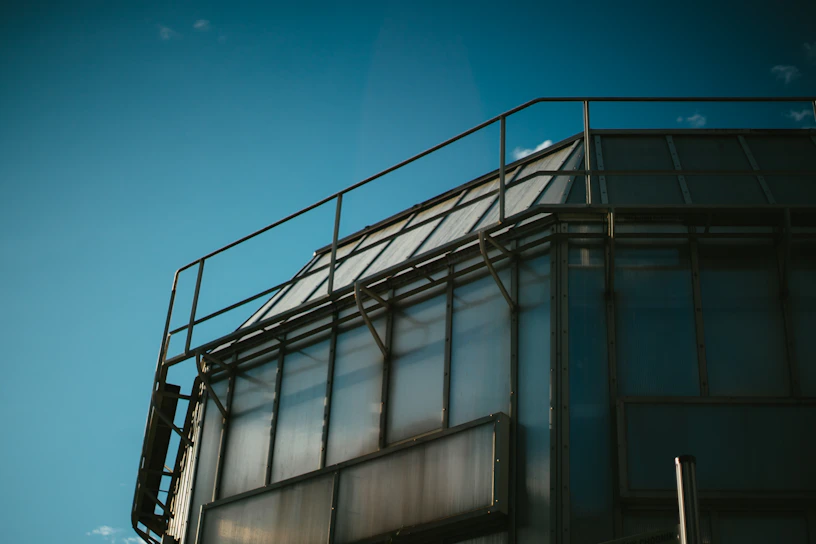 A panoramic view of a recently completed industrial facility showcasing sleek steel structures and clean lines under a bright sky.
