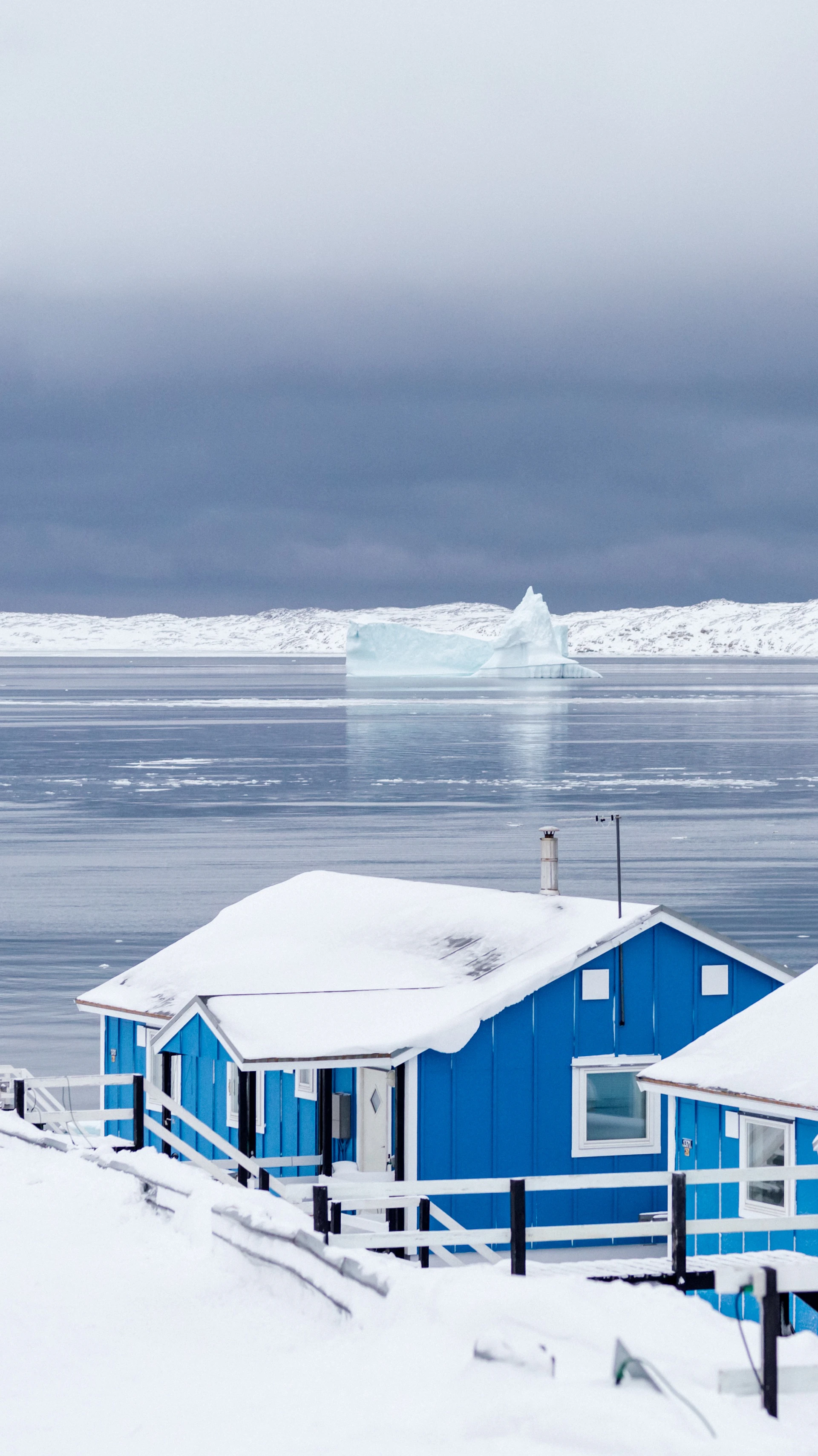 blue and white wooden house near body of water