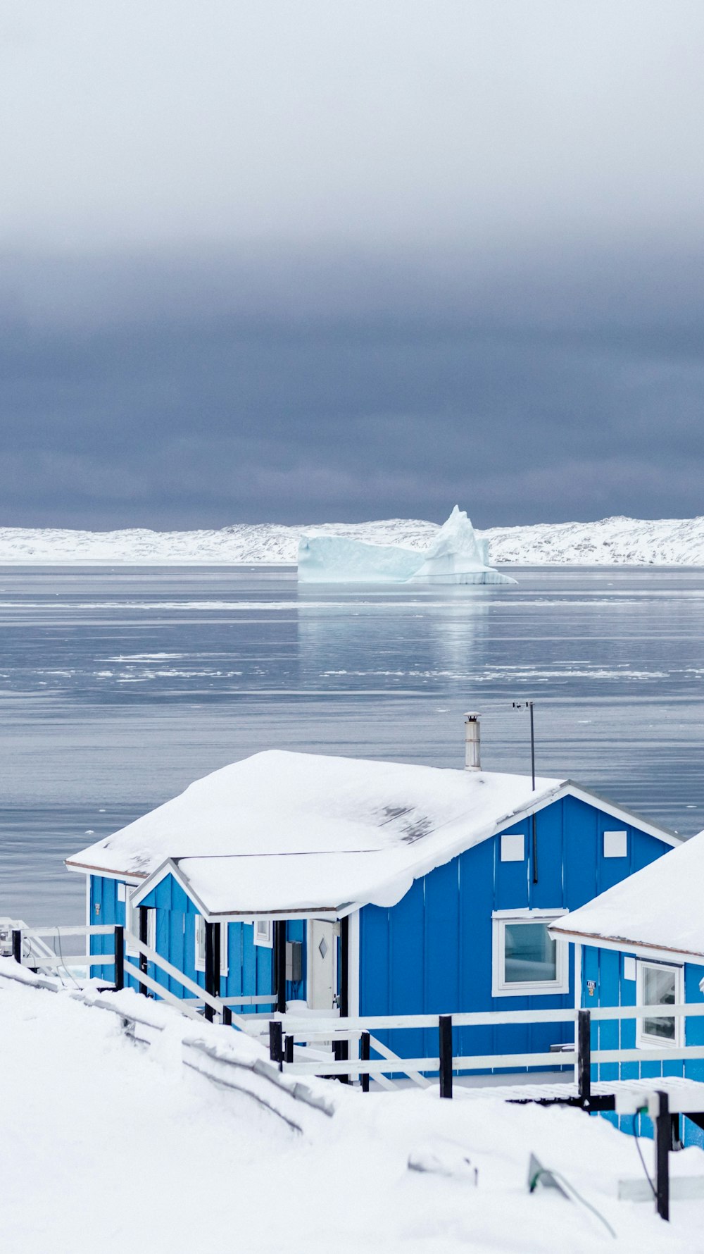 blue and white wooden house near body of water