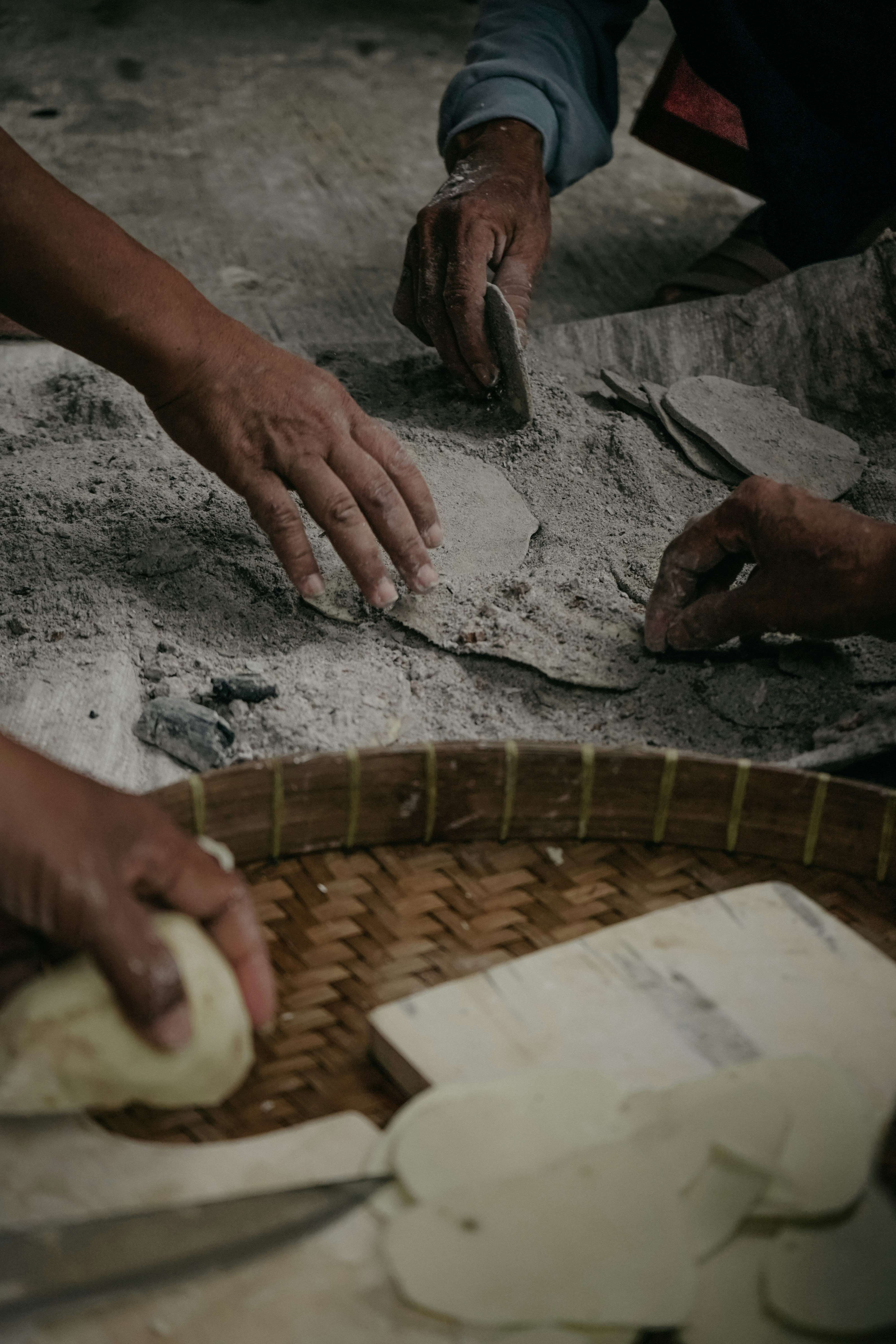 a person is kneading dough into a basket