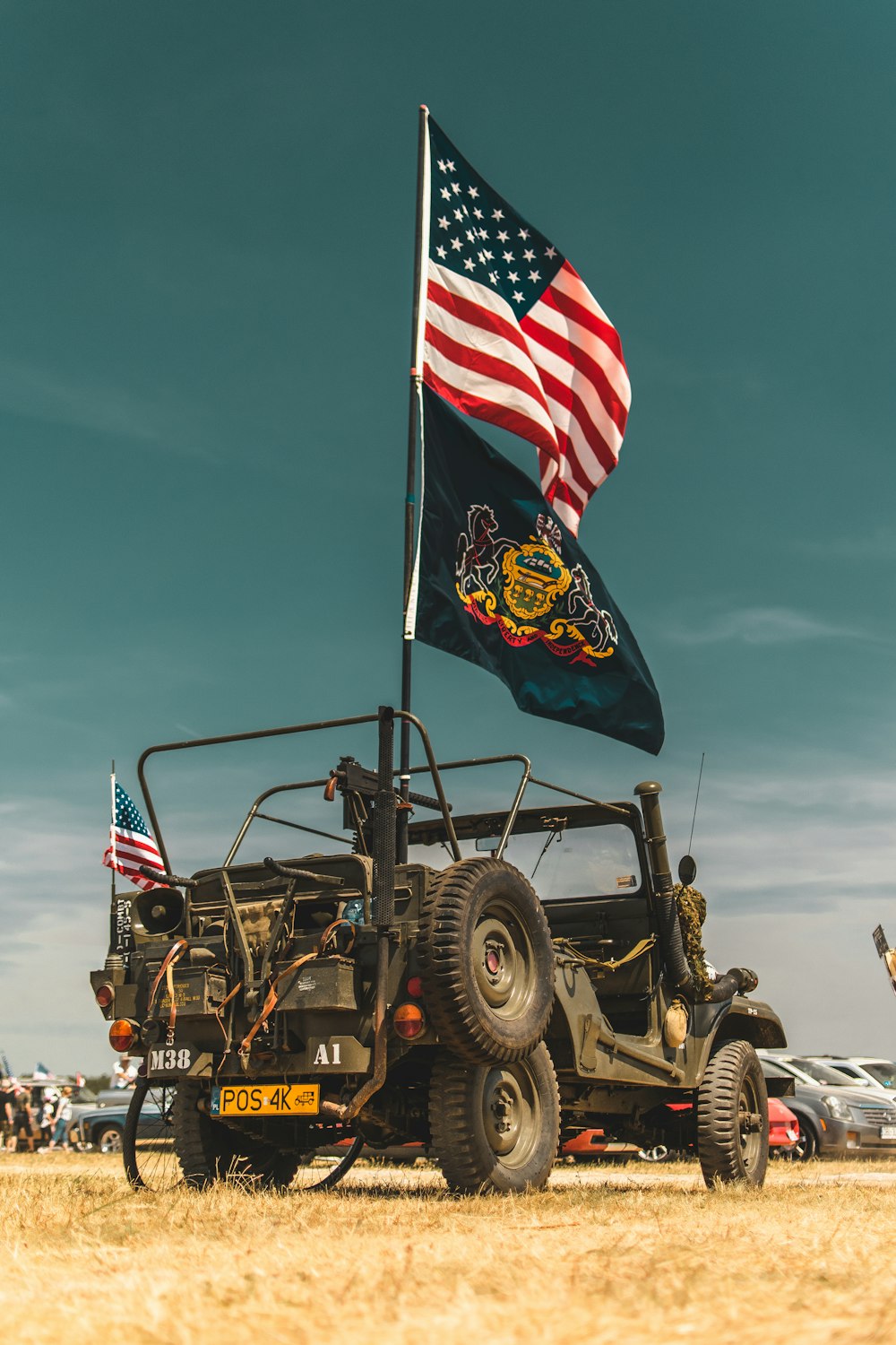 a jeep with an american flag on top of it